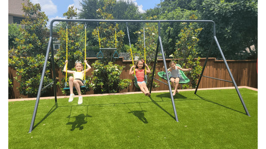 Three kids on a medium-sized swing set. 