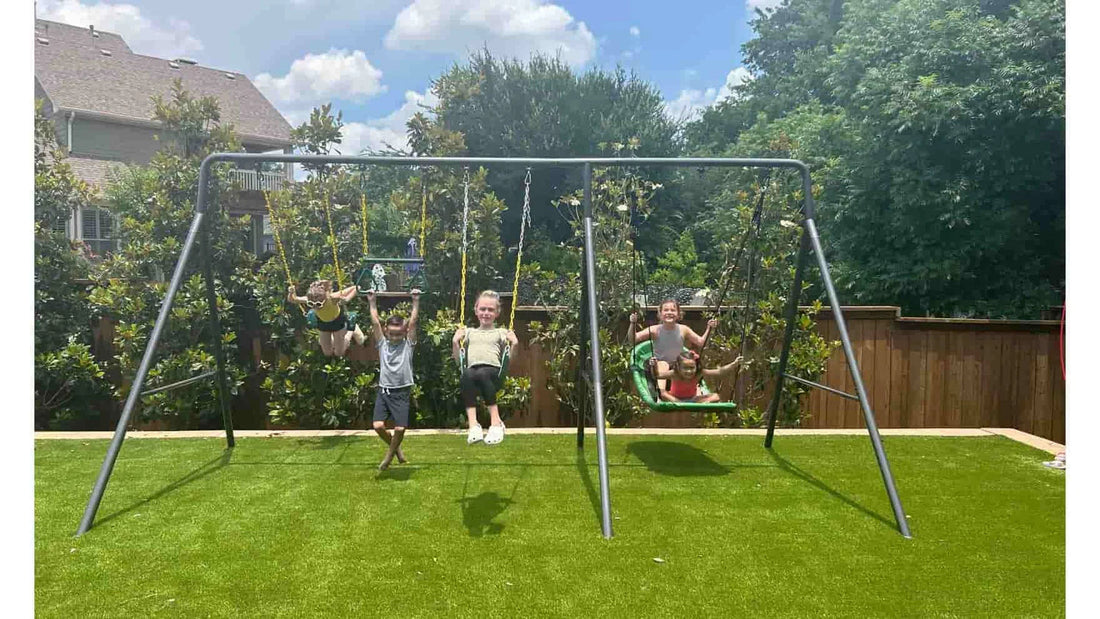 Five kids playing on a medium swing set. 